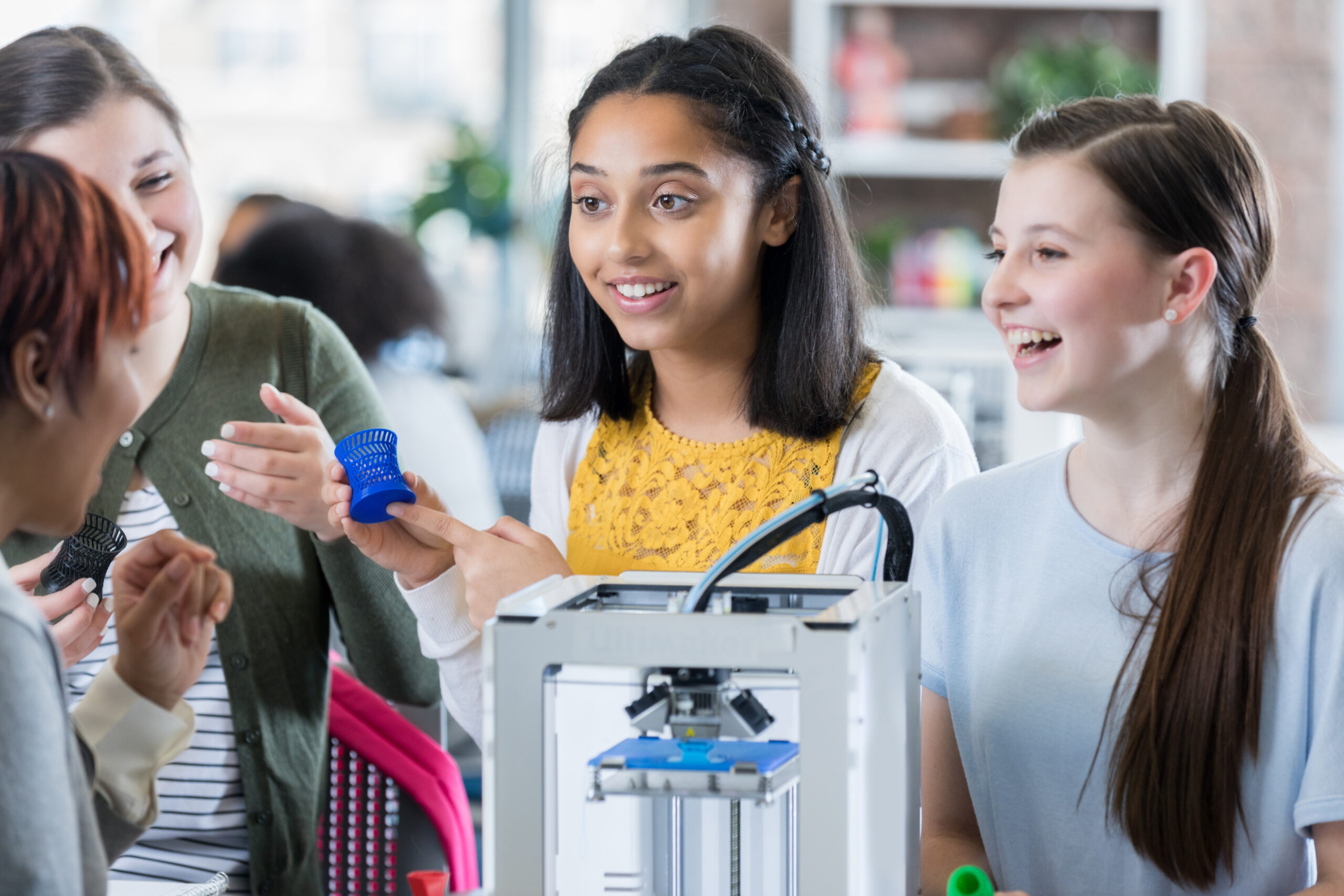 Excited high school student using 3D printer