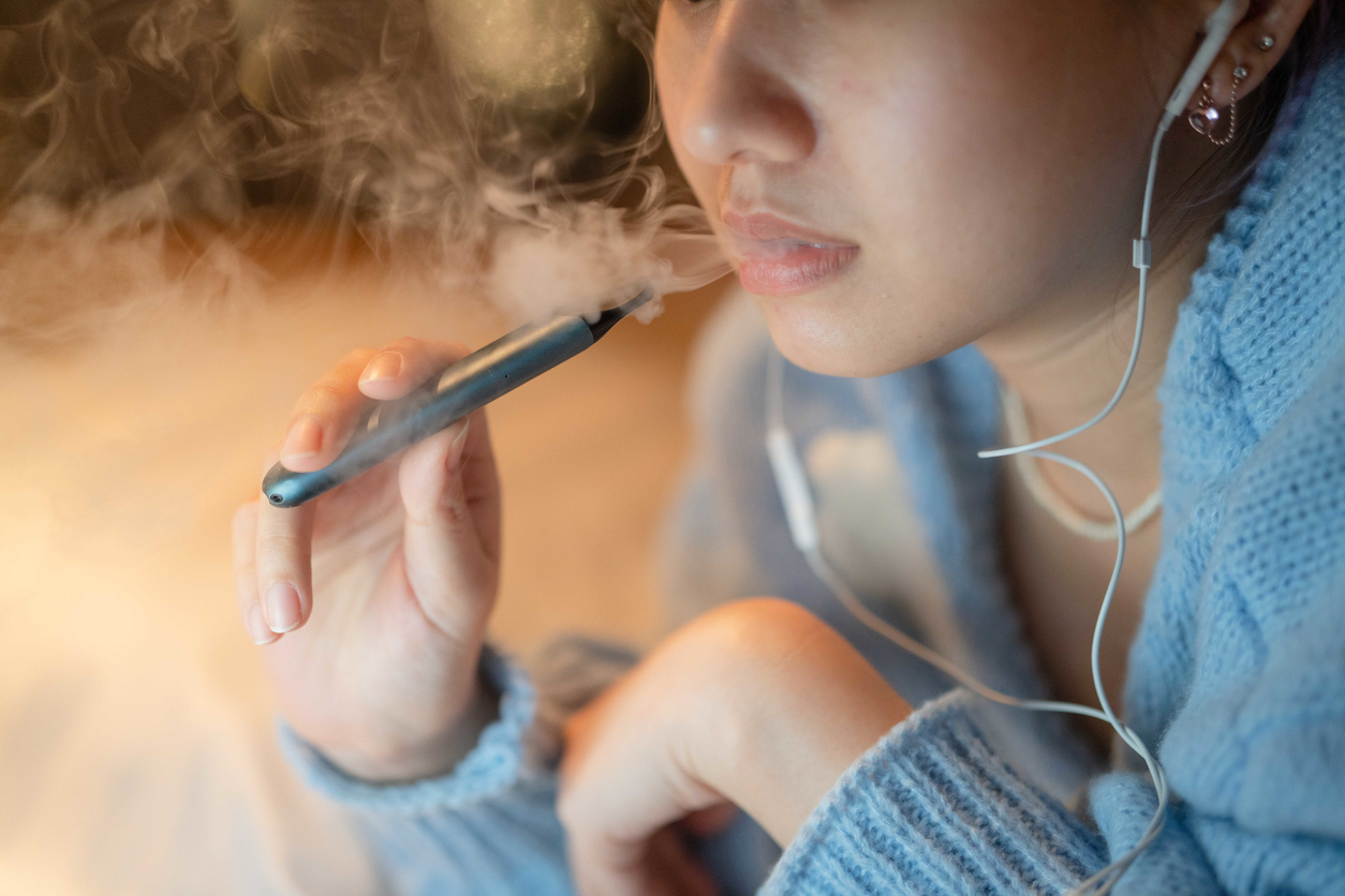 Young woman vaping an electronic cigarette