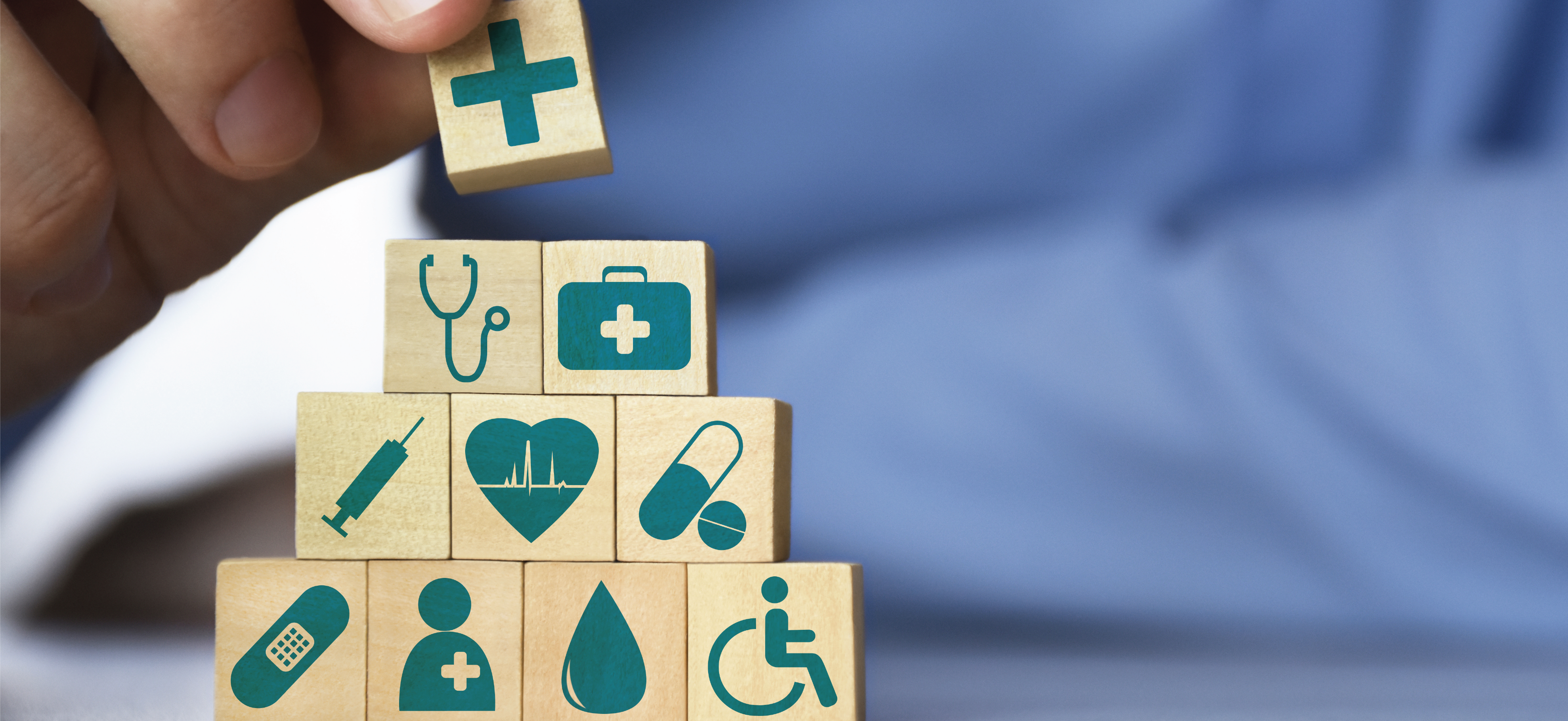 Building blocks with health-related icons on them